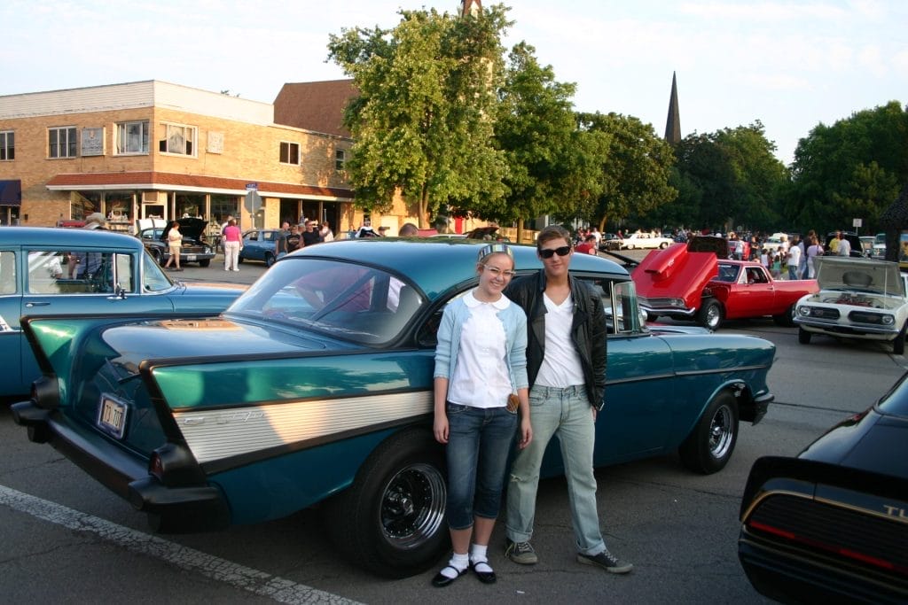 Dirty Bird's Annual Cruise Night with two people standing outside a car